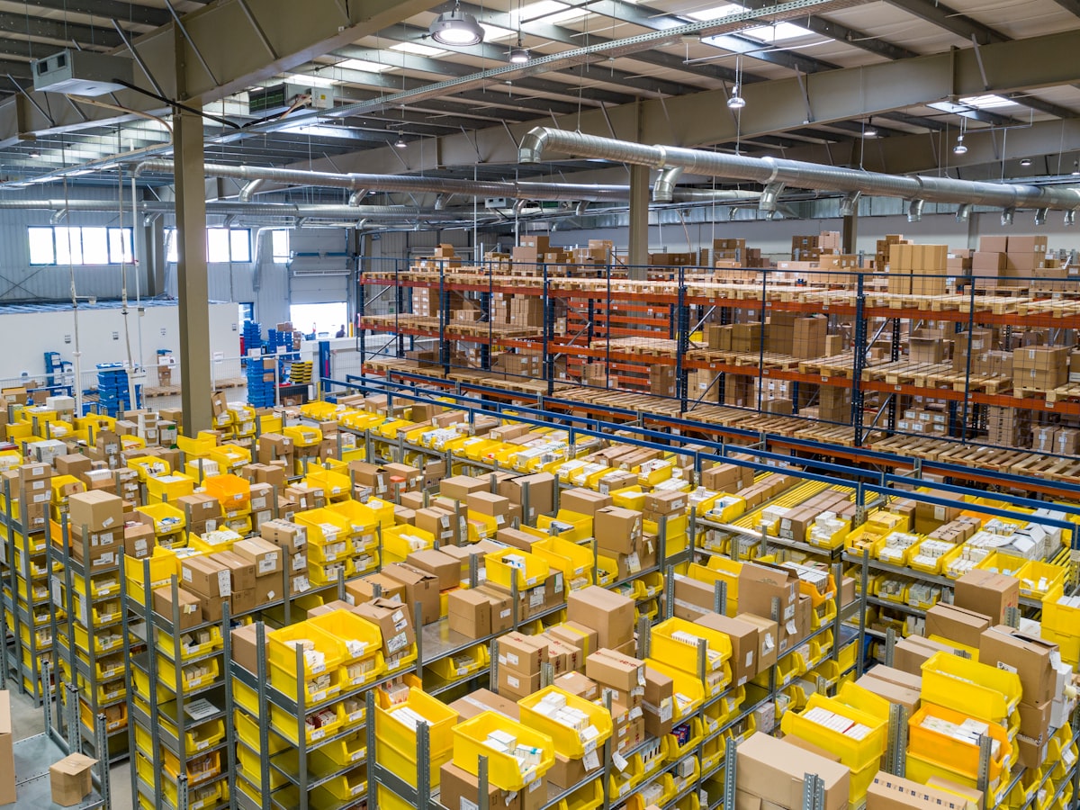 Warehouse aisle with stacked packaging and inventory.